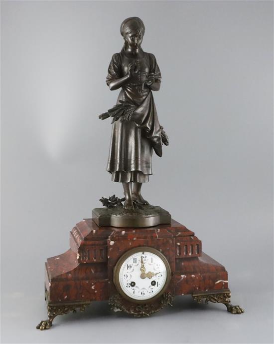 A 19th century French bronze and rouge marble mantel clock, width 15in. depth 7in. height 21.5in.